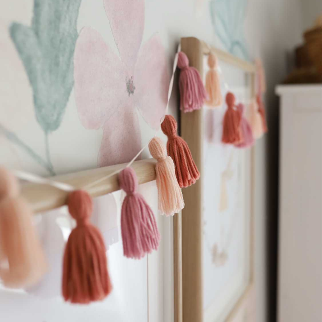 Pink boho tassel party garland used in a child's bedroom